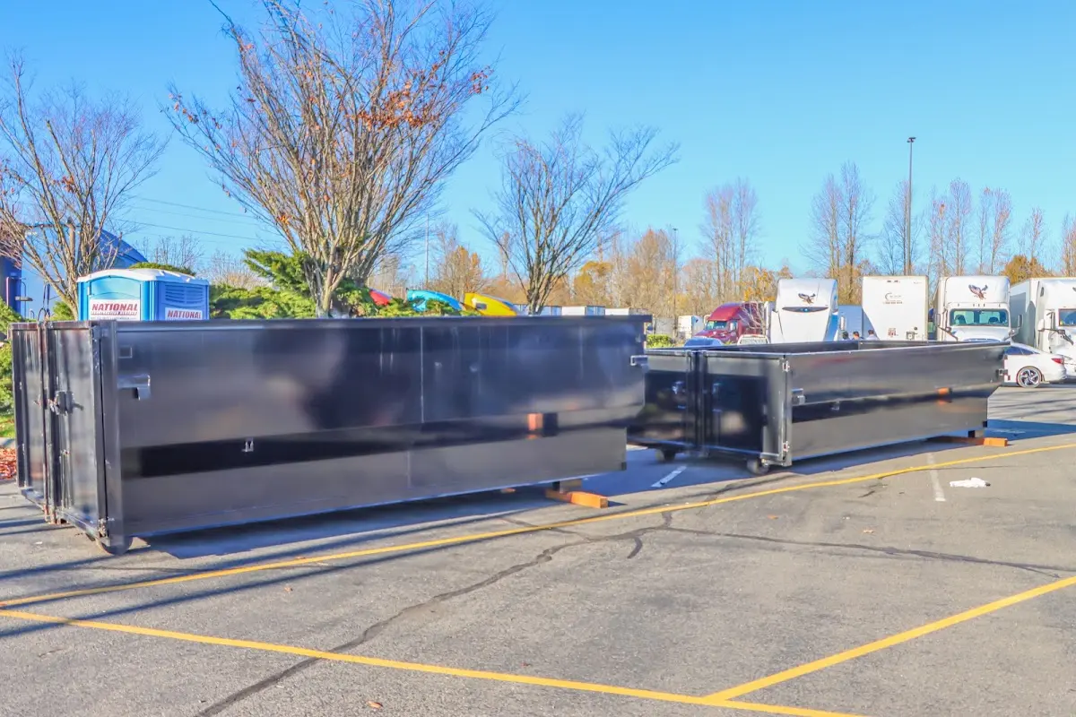 Professional dumpster rental service with roll-off container on residential driveway in Burke